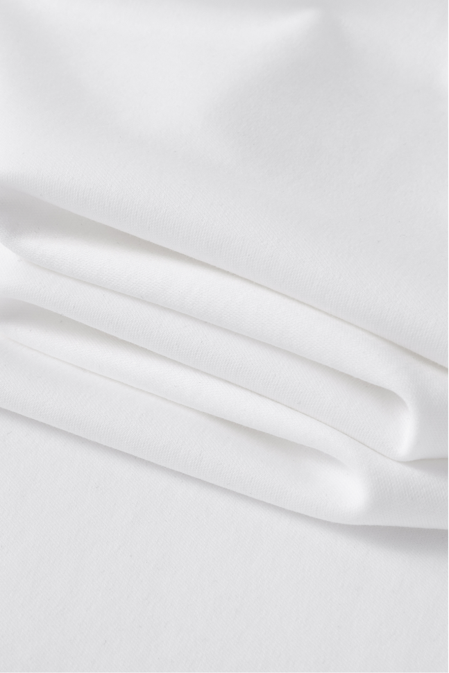 Close-up of the white T-shirt fabric with a smooth texture.